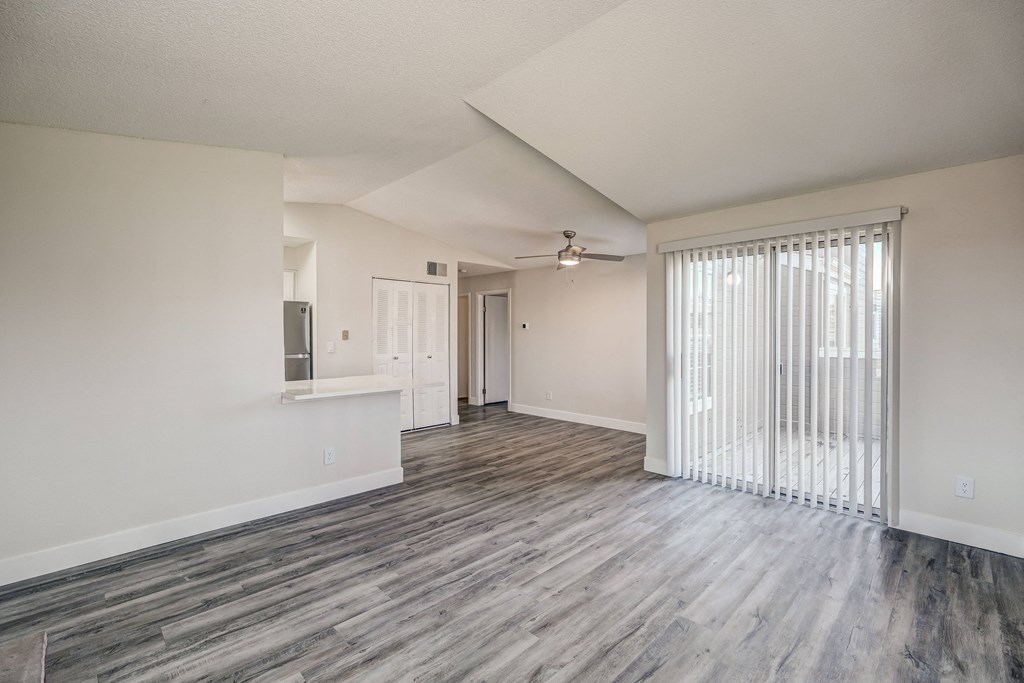 an empty living room with a sliding glass door