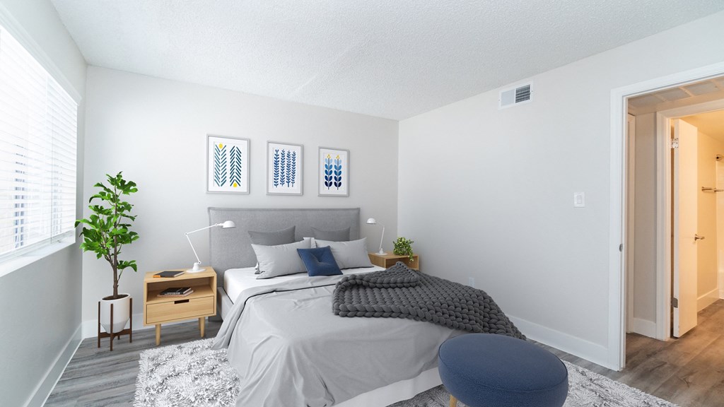 a bedroom with a bed and a chair in a 555 waverly unit
