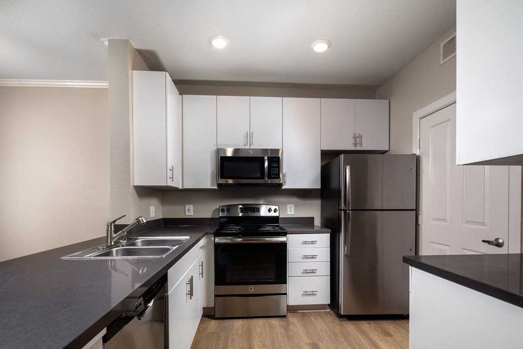 kitchen with stainless steel appliances and white cabinets