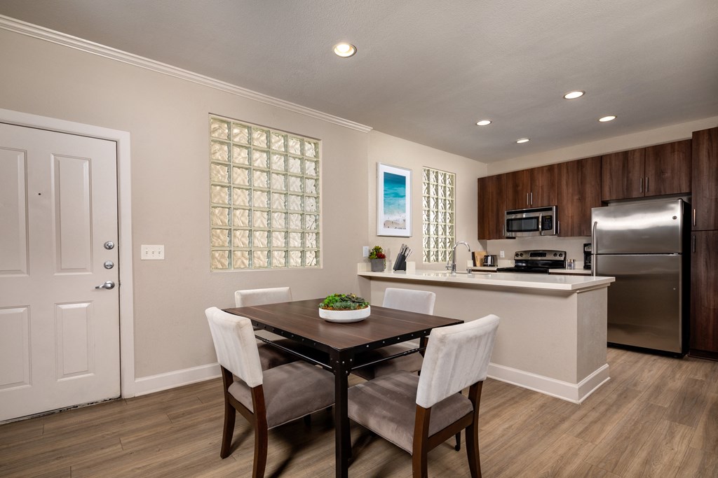 a kitchen and dining room with a table and chairs