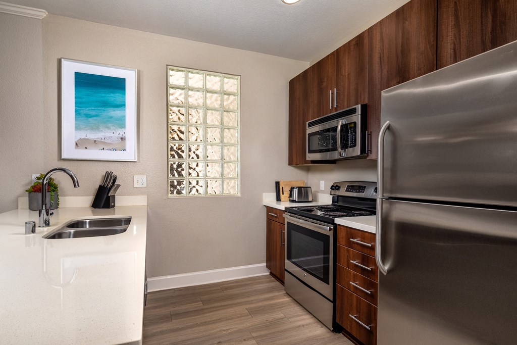 a kitchen with stainless steel appliances and a stainless steel refrigerator