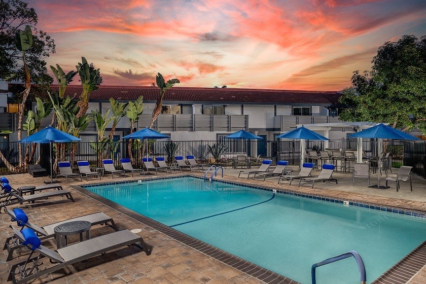 Stone Arbor Pool Deck with Lounge Chairs