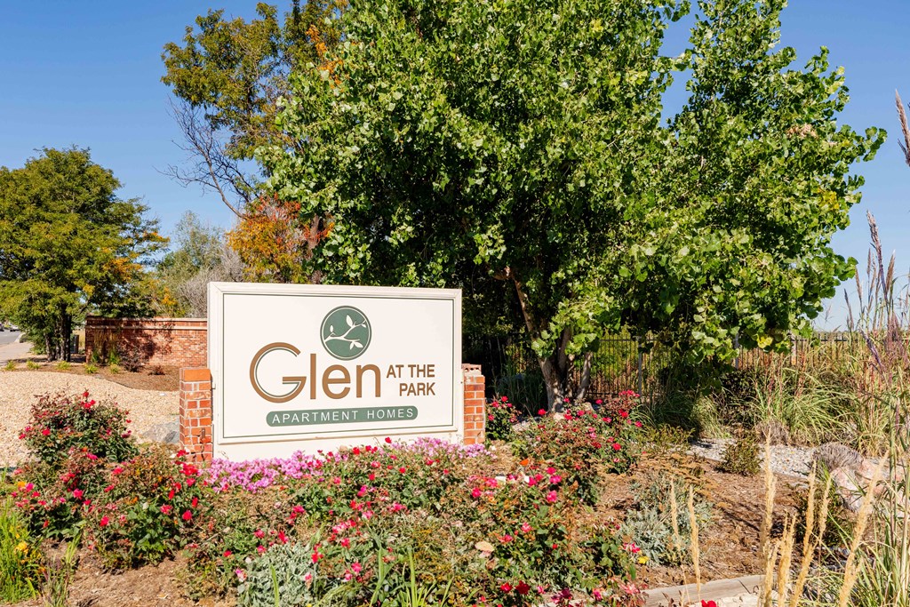 a sign for glen at the park in front of a tree