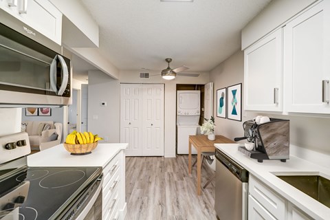 our spacious kitchen and living room are equipped with stainless steel appliances and white cabinets