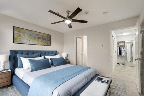 a bedroom with a large bed and a ceiling fan