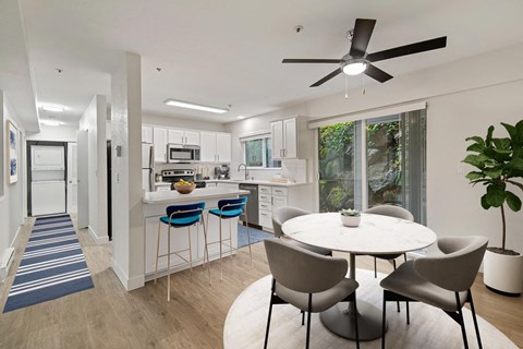 an open kitchen and dining area with a table and chairs