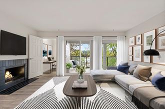 a living room with a couch and a coffee table and a fireplace