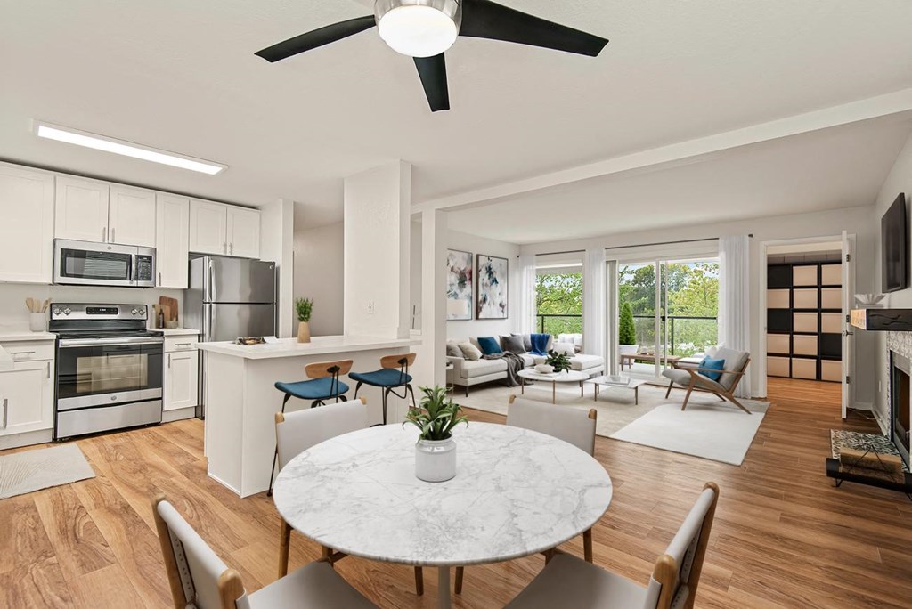 an open living room and kitchen with a table and chairs