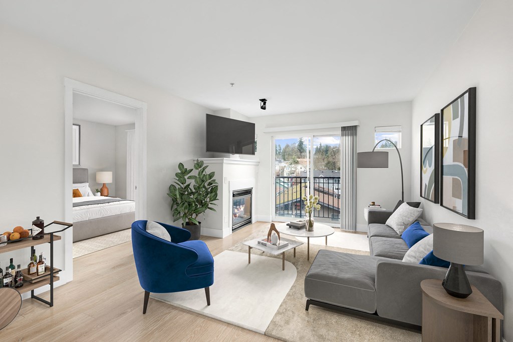 a bedroom with a bed and a living room with a couch and a chair