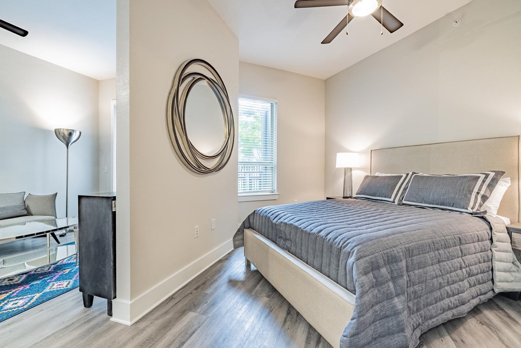 a bedroom with a bed and a ceiling fan