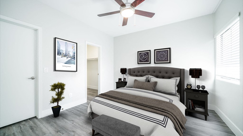 a bedroom with a large bed and a ceiling fan