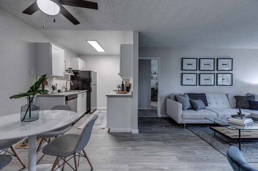 an open concept living room and kitchen in an apartment