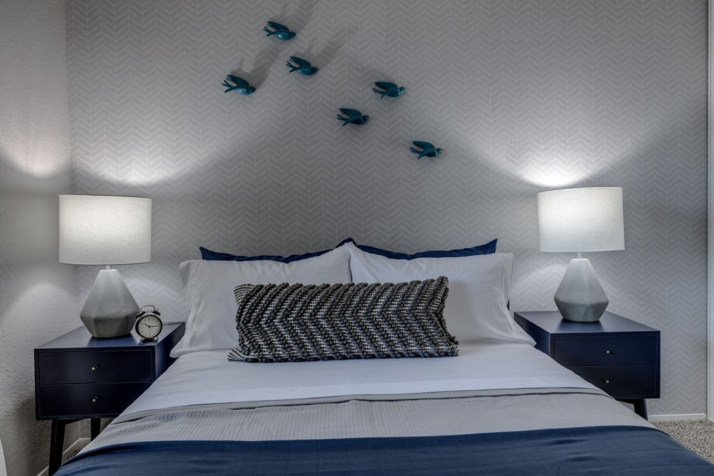 a bedroom with a bed and two night stands with lamps
