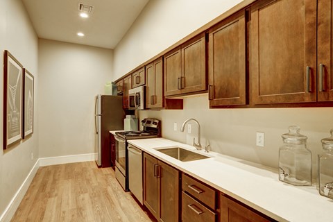 a kitchen with wooden cabinets and white countertops