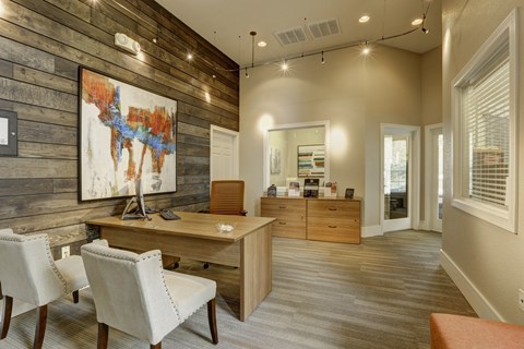 a home office with a reclaimed wood wall and hardwood flooring