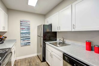 a kitchen with white cabinets and stainless steel appliances - Photo Gallery