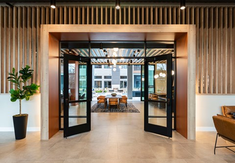 A modern interior with a large open doorway leading to a dining area.