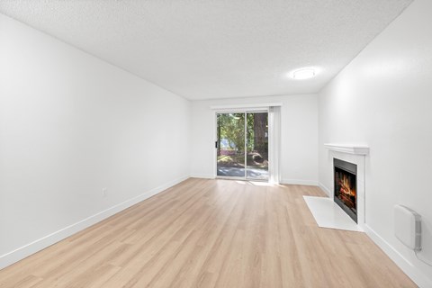 A room with a fireplace and a window.