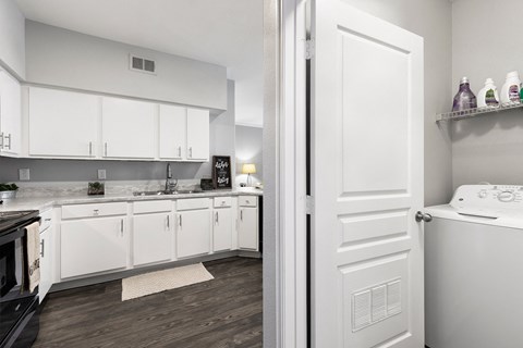 a kitchen with white cabinets and a stove and a refrigerator