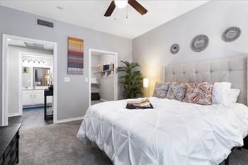 Bedroom + Closet Master bedroom with large closet and entrance to bathroom - Photo Gallery 5