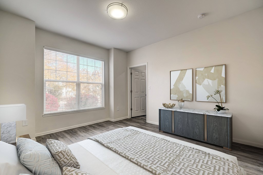 a bedroom with a bed and a dresser and a window
