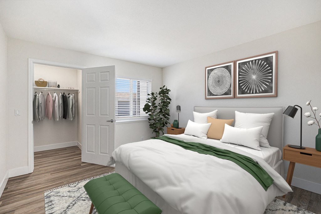 A bedroom with a white bed and a green pillow.