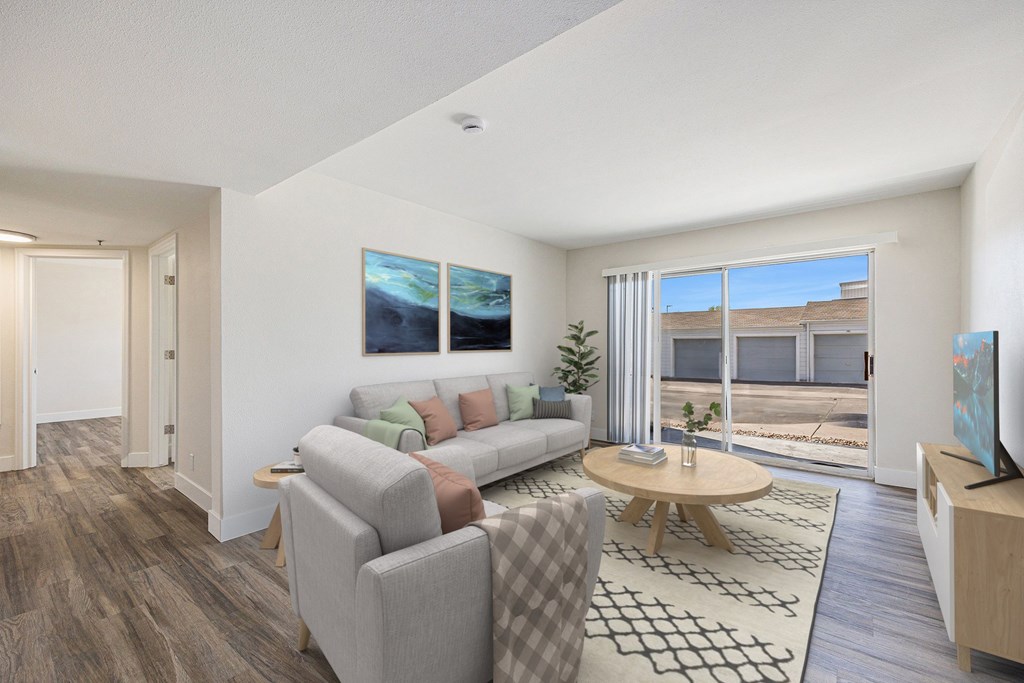 A living room with a grey couch and a wooden coffee table.