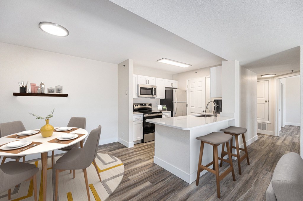 A modern kitchen with a dining table set for four.