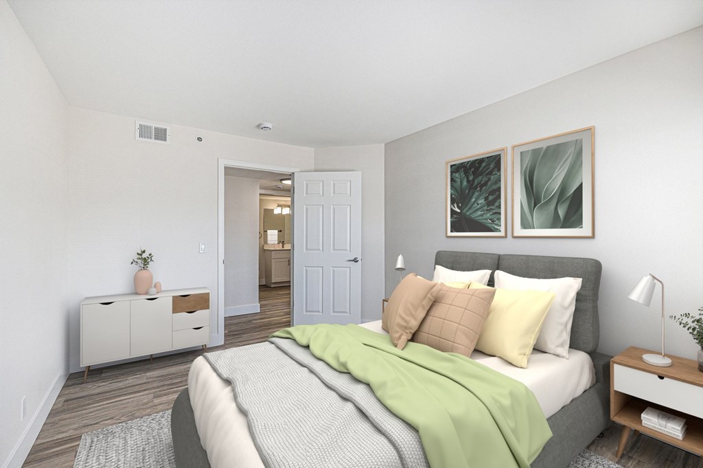 A bedroom with a bed, nightstand, and a cabinet.