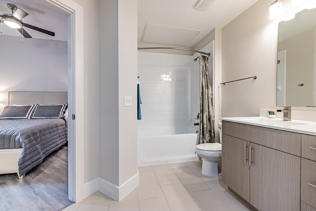 a bedroom with a bed and a toilet in a room