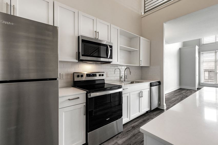 a kitchen with white cabinets and stainless steel appliances - Photo Gallery