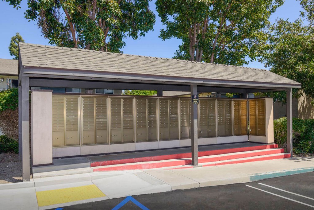 a covered bus stop with a row of names and addresses on the wall