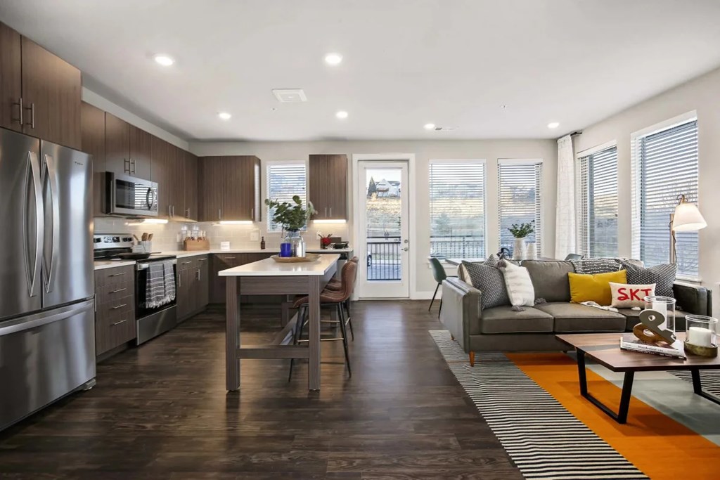 A modern kitchen with a dining table and a couch.
