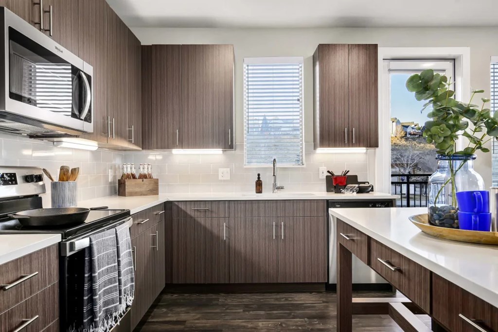 A kitchen with brown cabinets and a white counter.