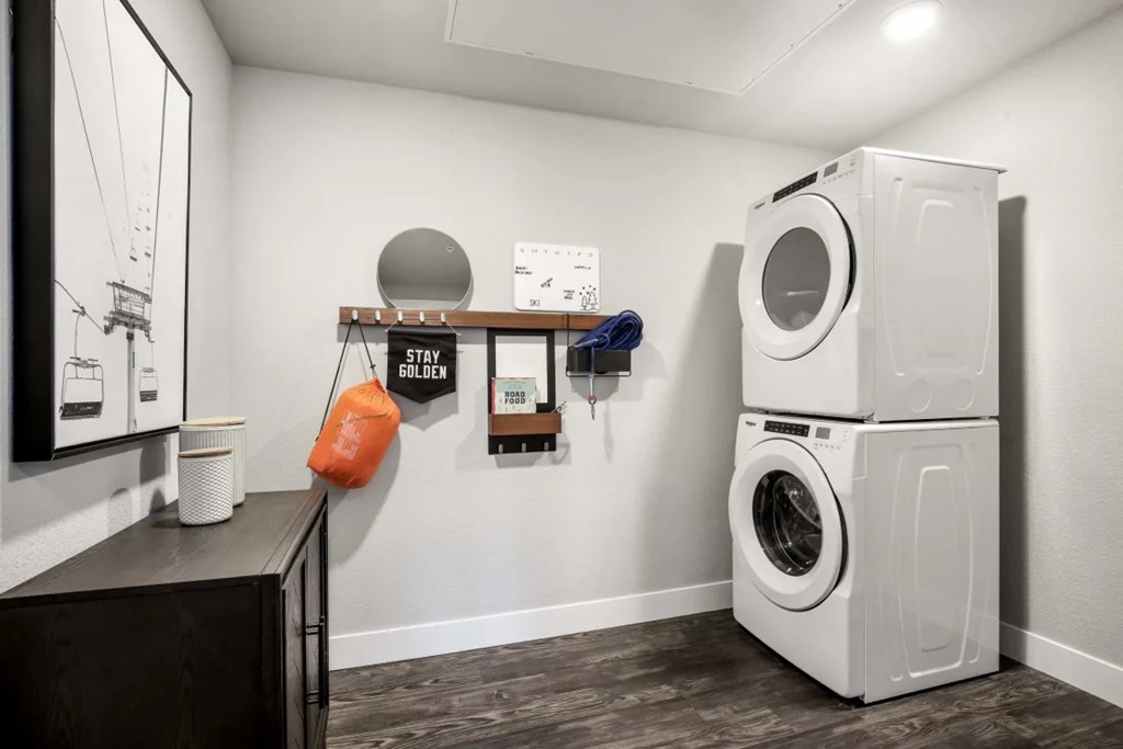 A washing machine is stacked on top of another in a laundry room.