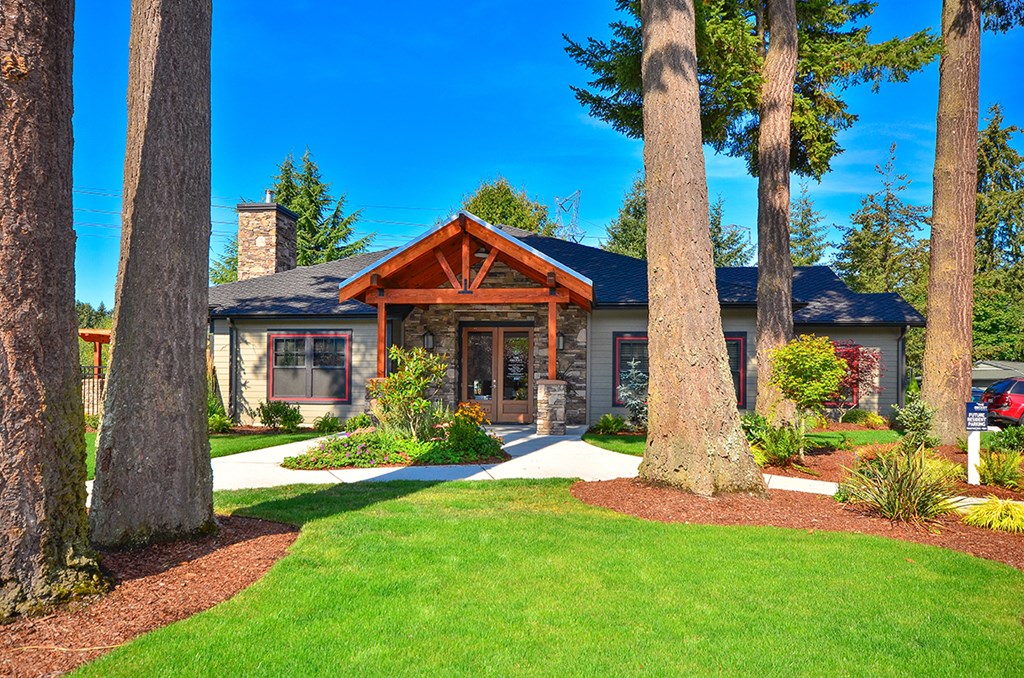 a home with large trees in front of it