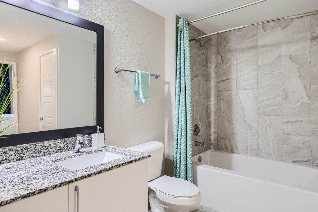 a bathroom with a sink toilet and bathtub