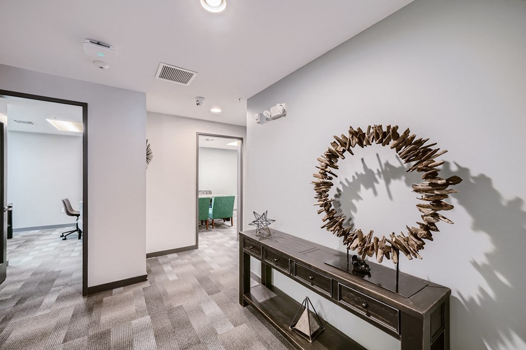 a hallway with a large mirror and a wooden table