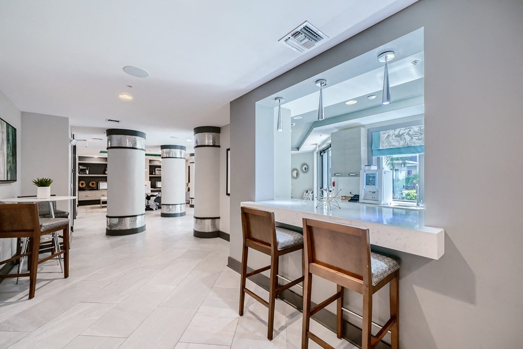 a bar with chairs and a counter in a lobby
