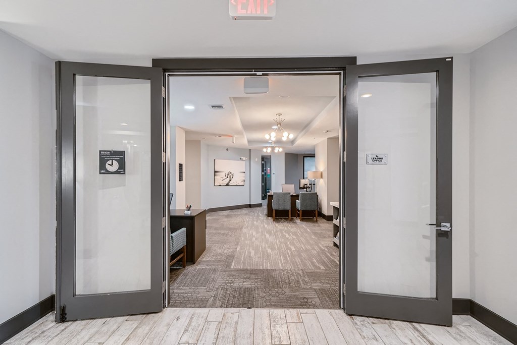 a lobby with glass doors and a conference room