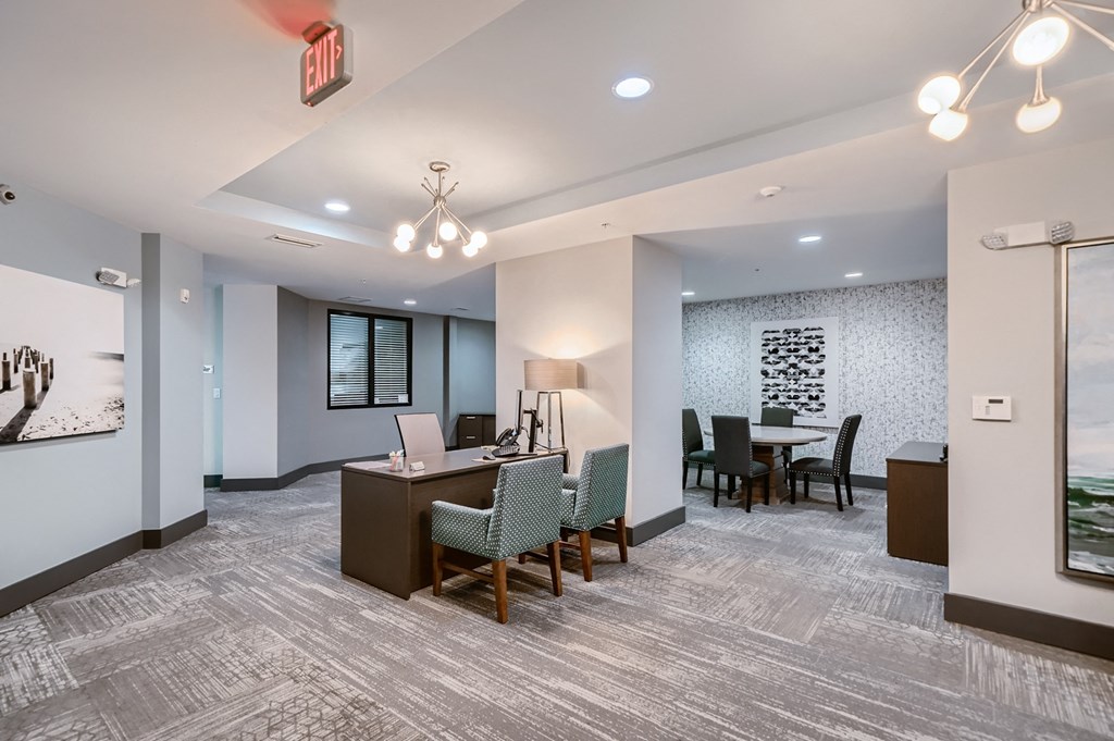 a conference room with a desk and chairs and a table