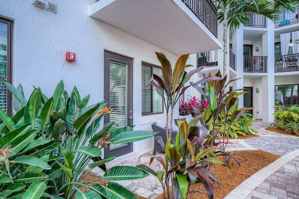 a building with tropical plants in front of it