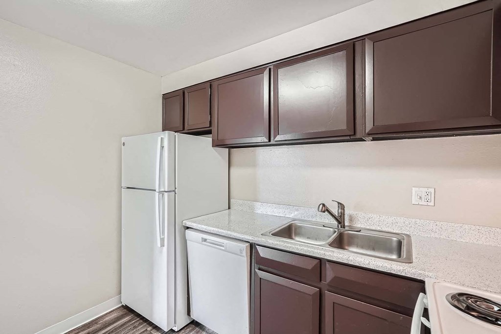 a kitchen with a sink and a refrigerator