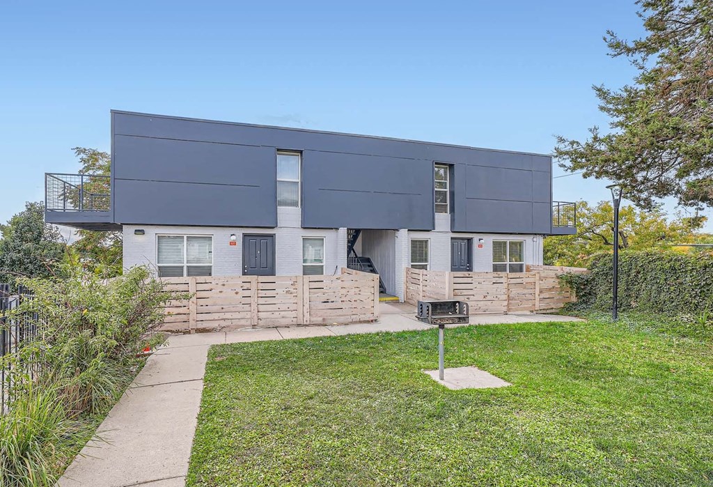 the front of a house with a yard and a sidewalk