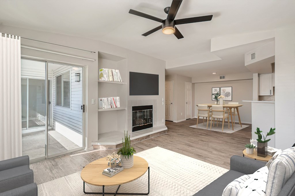 a living room with a fireplace and a sliding glass door