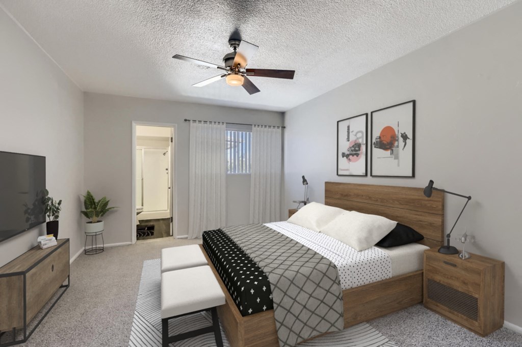a bedroom with a bed and a ceiling fan