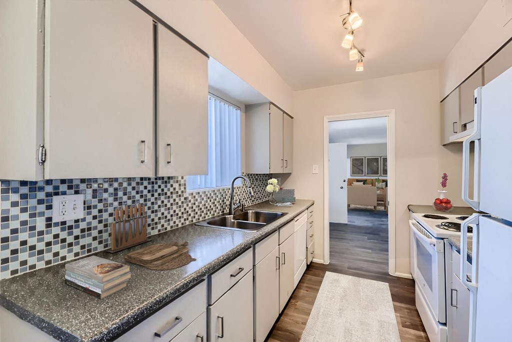 a kitchen with white cabinets and a counter top