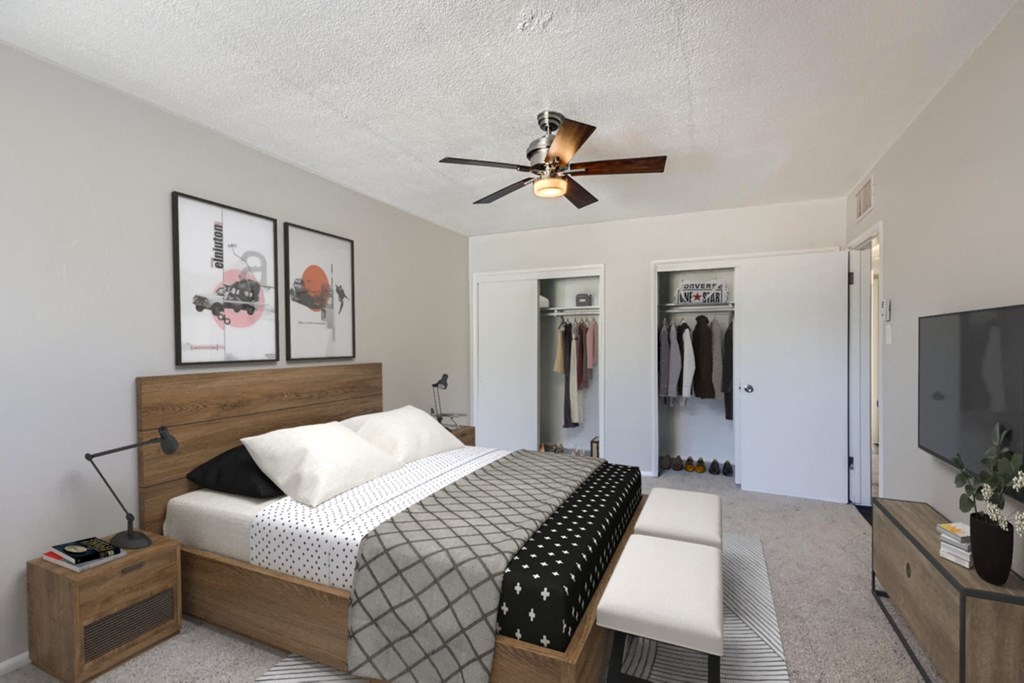 a bedroom with a bed and a ceiling fan