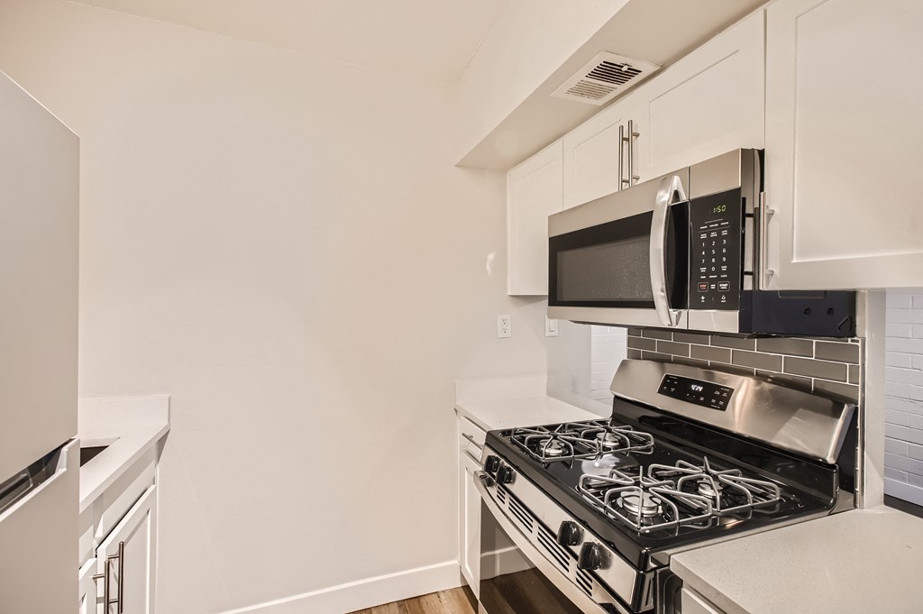 a kitchen with a stove and microwave in a 555 waverly unit