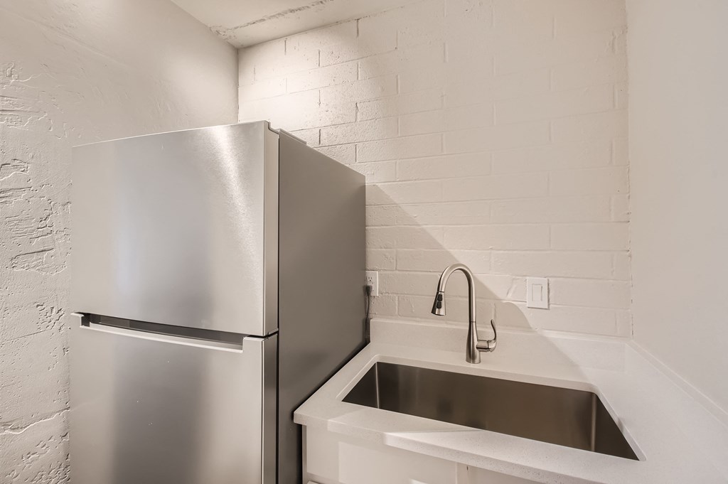 a kitchen with a sink and a refrigerator